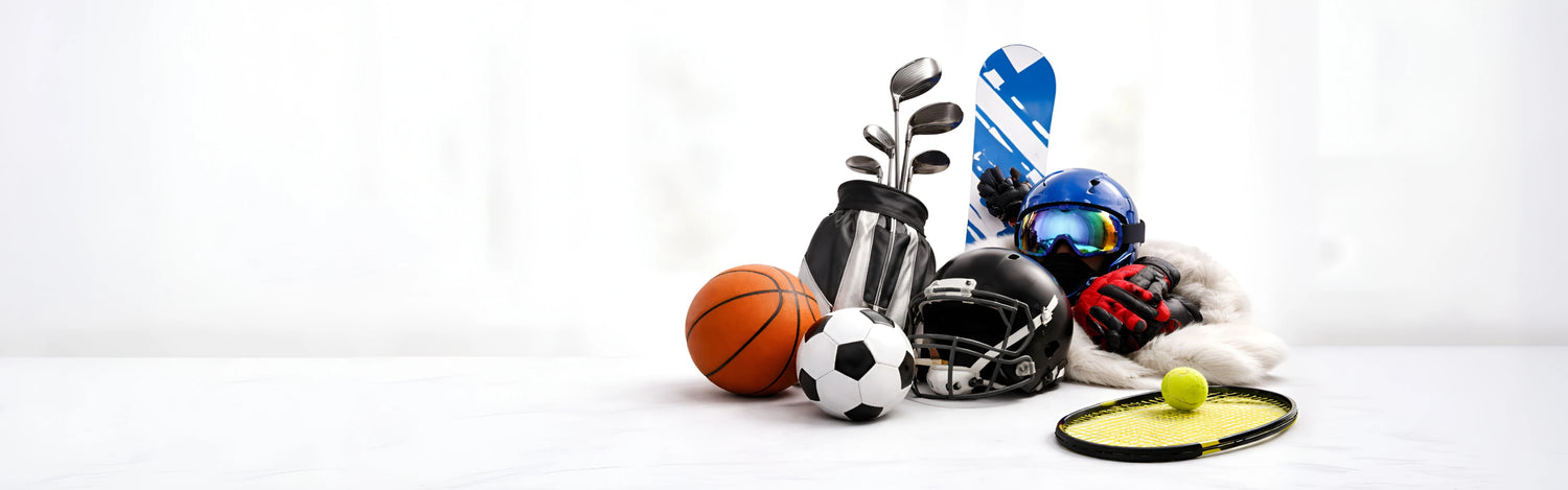Collection of sports equipment including a basketball, soccer ball, and tennis racket on a white background